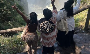 group travellers on victoria waterfall